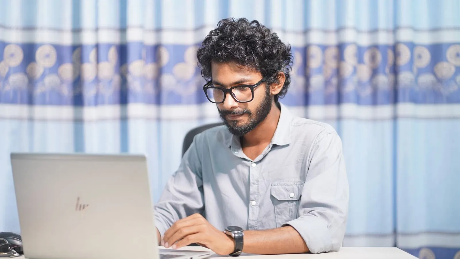 Web designer working on a laptop, elevating a business’s online presence