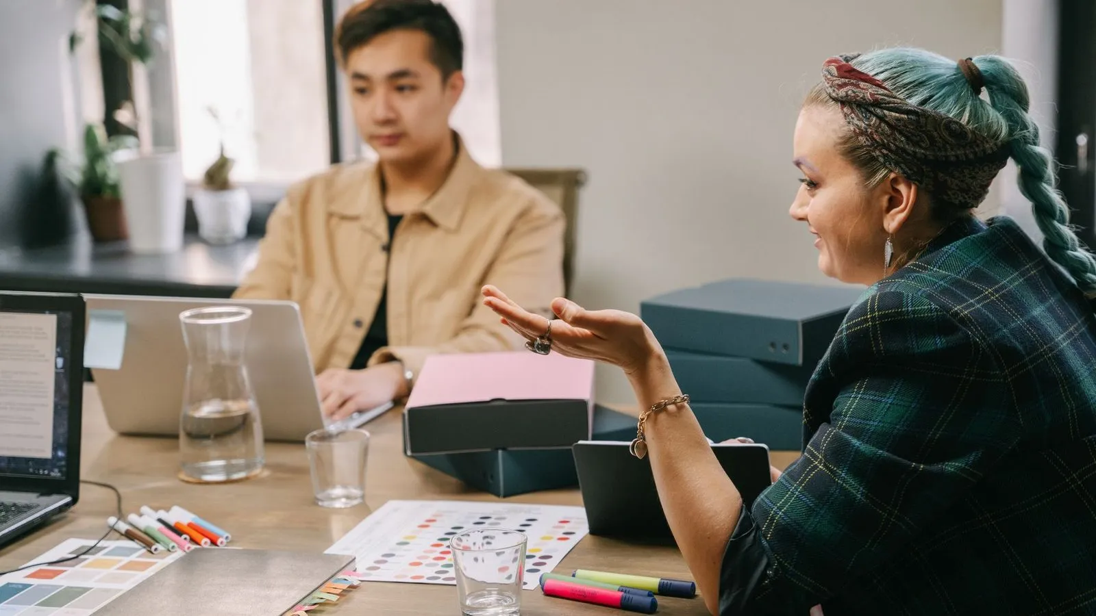 Two coworkers in a strategy meeting, choosing a web design agency in Redding, CA