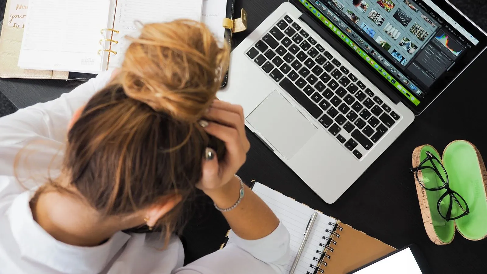 Stressed business owner at a laptop, illustrating why DIY website builders fail local businesses